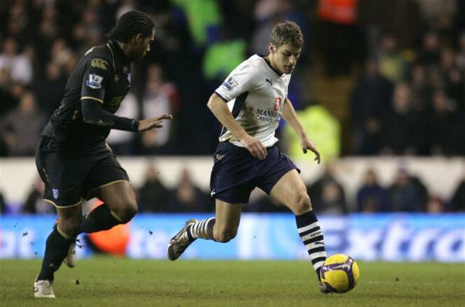 David Bentley takes-on Portsmouth's Glen Johnson